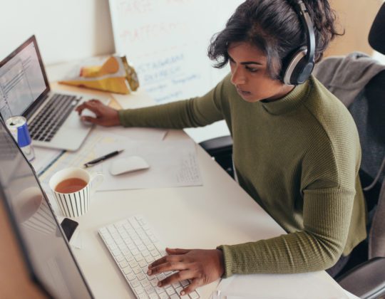 student in software engineer bootcamp learning to code on computer