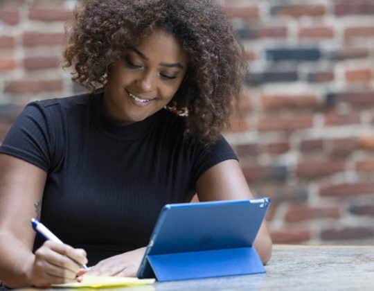 Young woman learning Data Analytics on a tablet