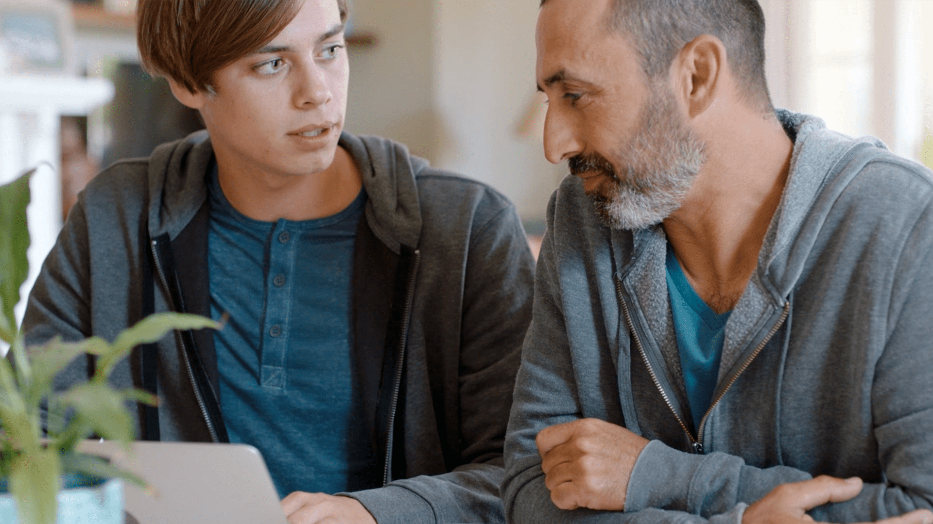 Young teenager and older man talking